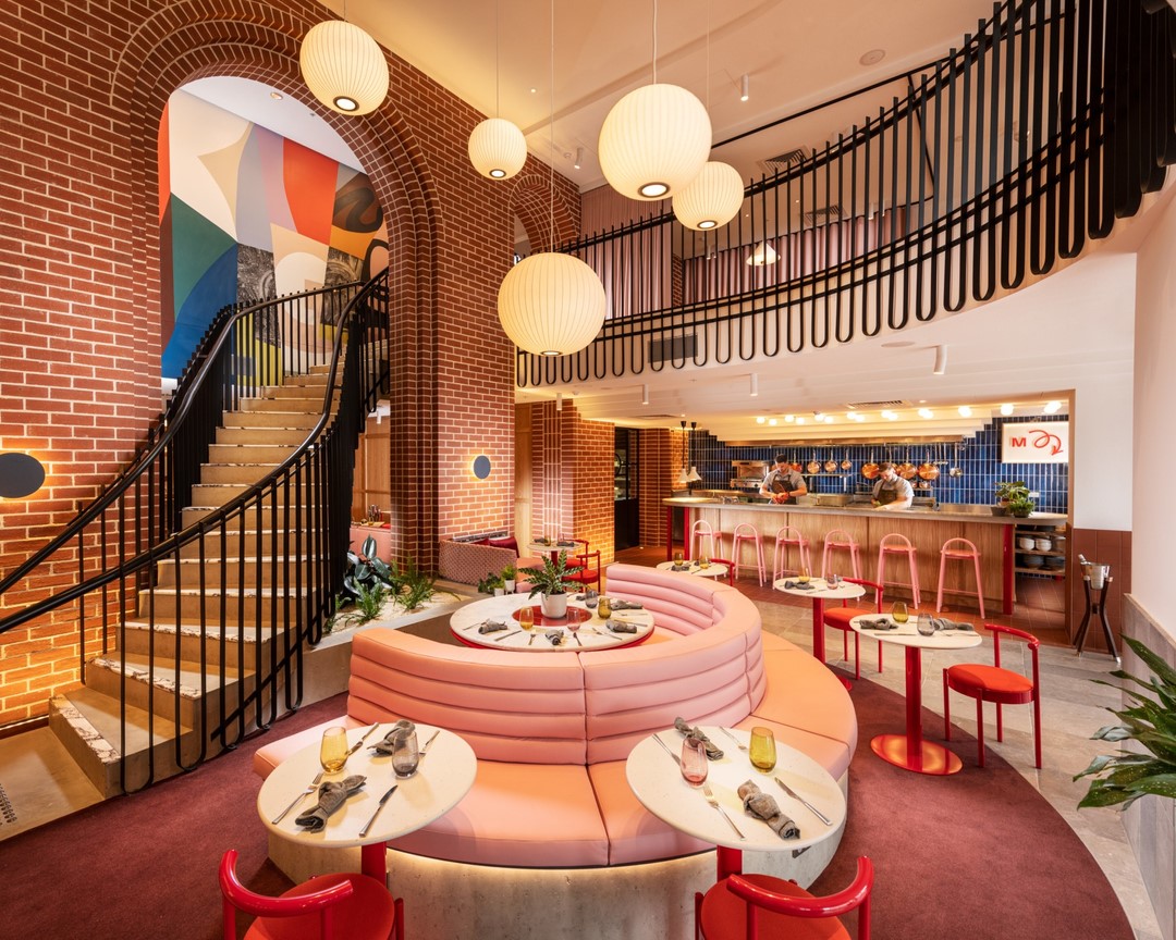 interior of hotel indigo, with a pink curved lounge area