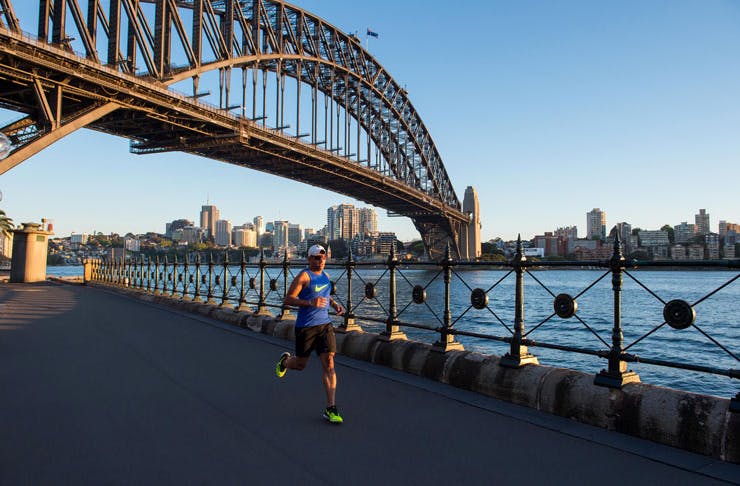A jogger runs under the Harbour Bridge in Sydney. 