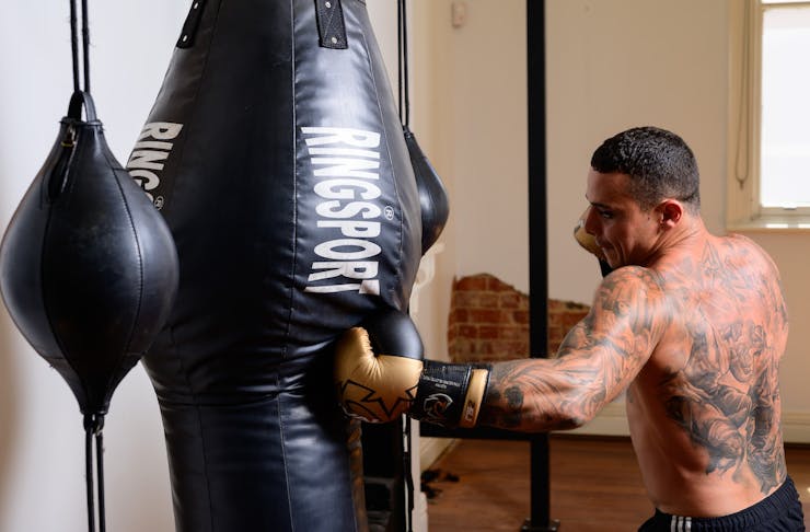 A man boxing with a punching bag.
