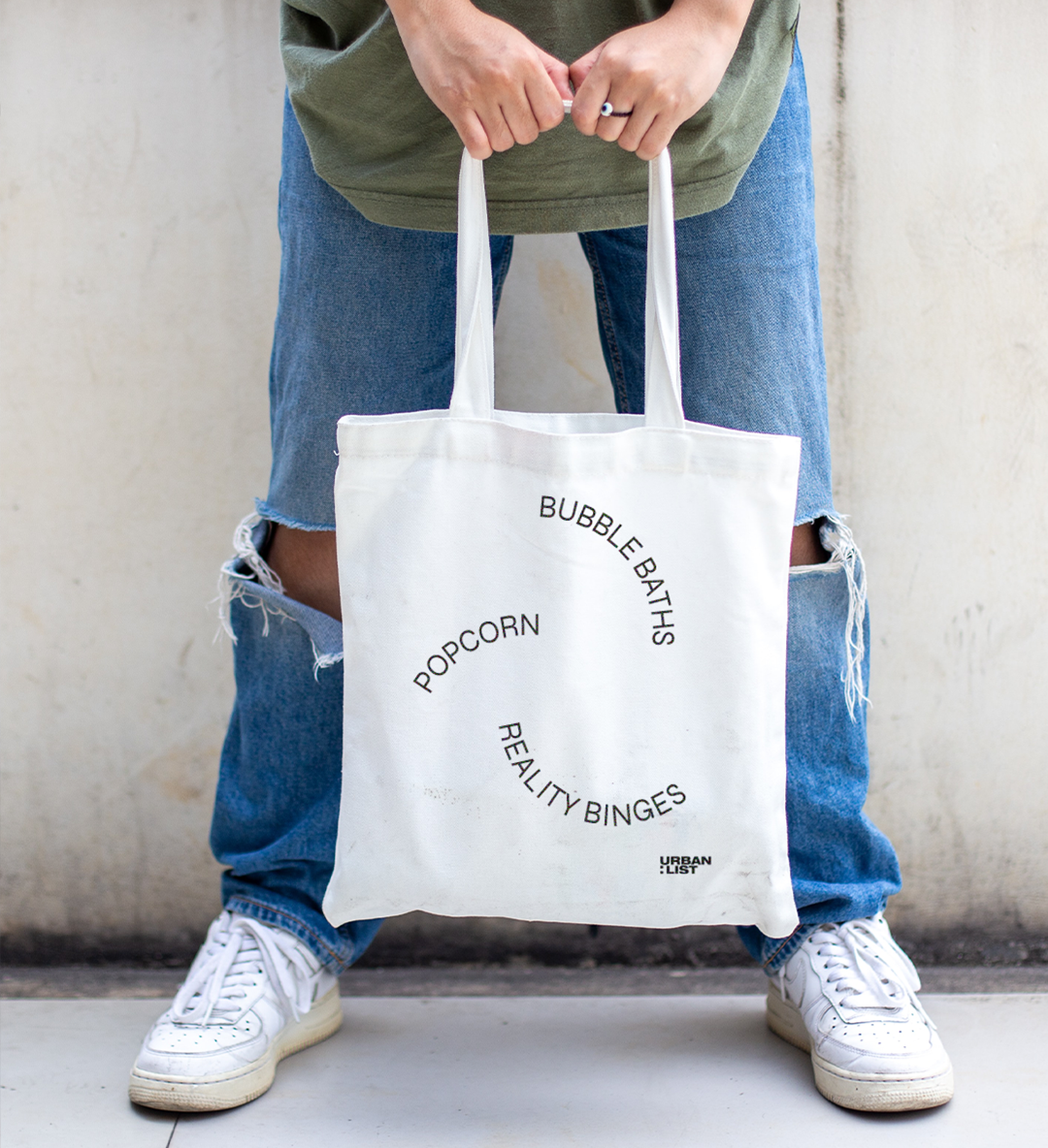 a person holding a tote bag
