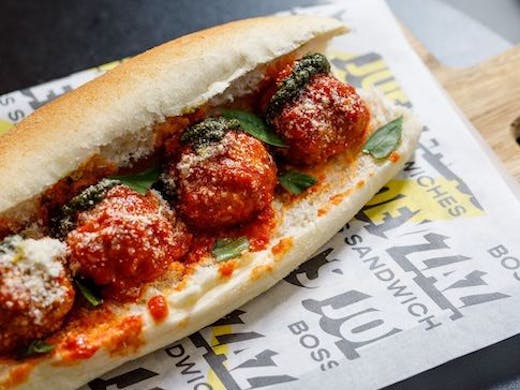 A meatball sub from joey Zazas sits on a piece of greaseproof paper