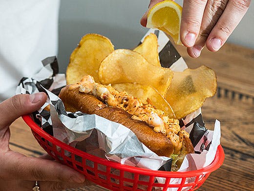 The lobster roll at the crab shack is getting lemon squeezed over the top.