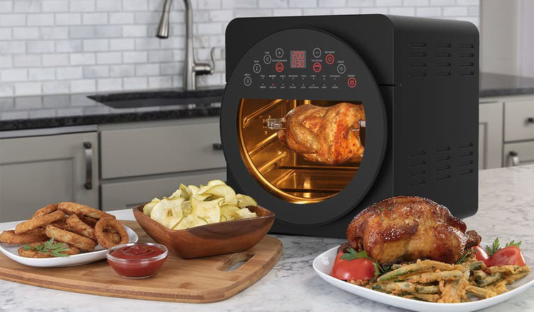 A block air fryer with a large window on a kitchen bench.