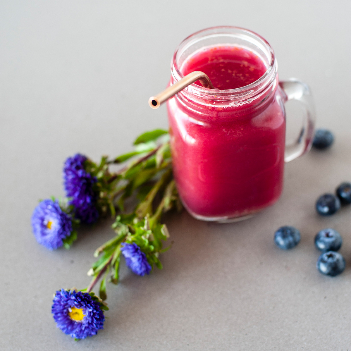 a pink smoothie in a glass mason jar 