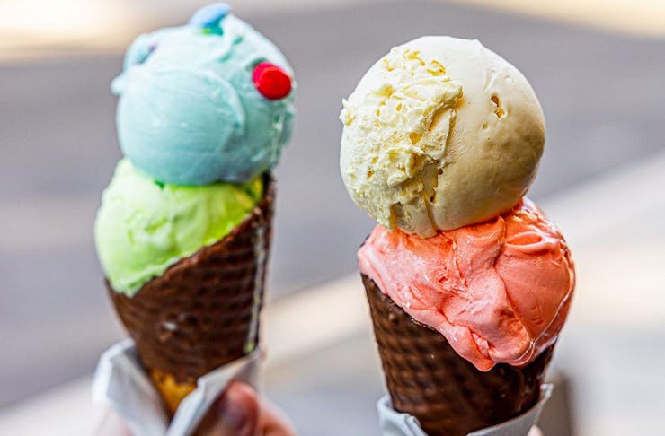 brightly coloured scoops of gelato in cones