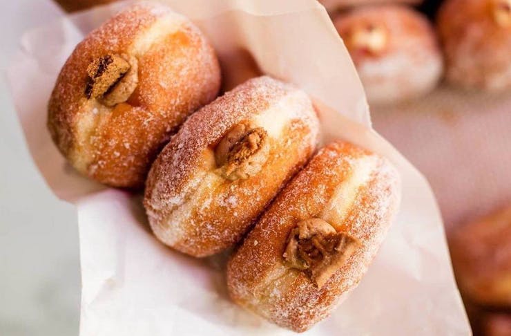 person holding doughnuts at one of Perth's best markets