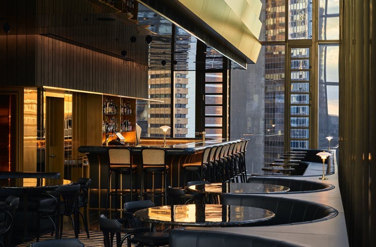 The brass bar and black leather booths at Dean and Nancy on 22 bar in Sydney