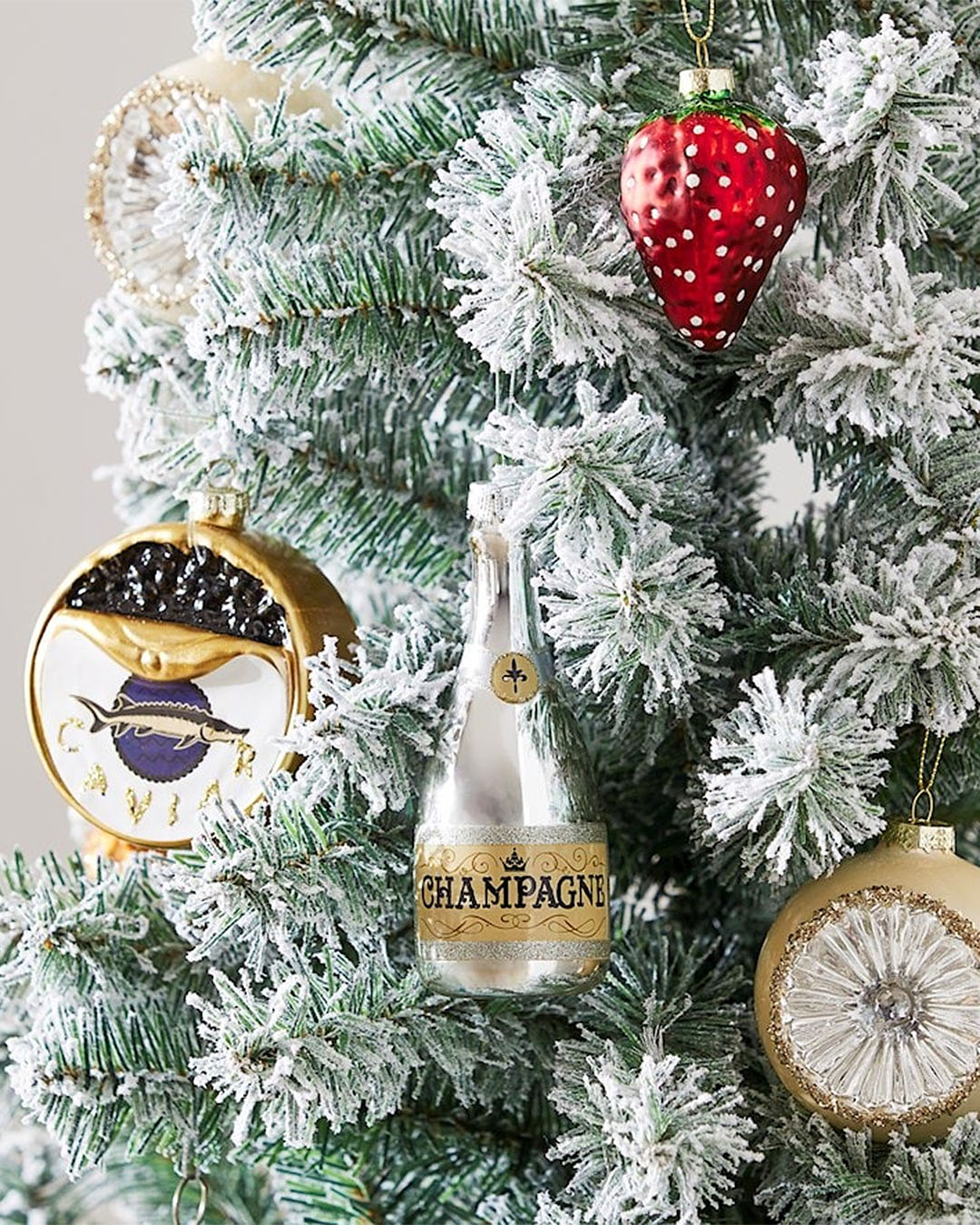 Caviar and champagne christmas decorations on a tree.