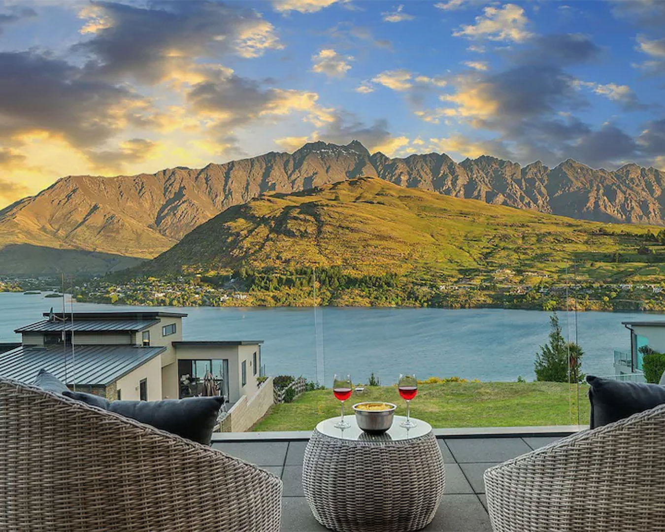 A few seats and glasses of wine overlook stunning mountain views.