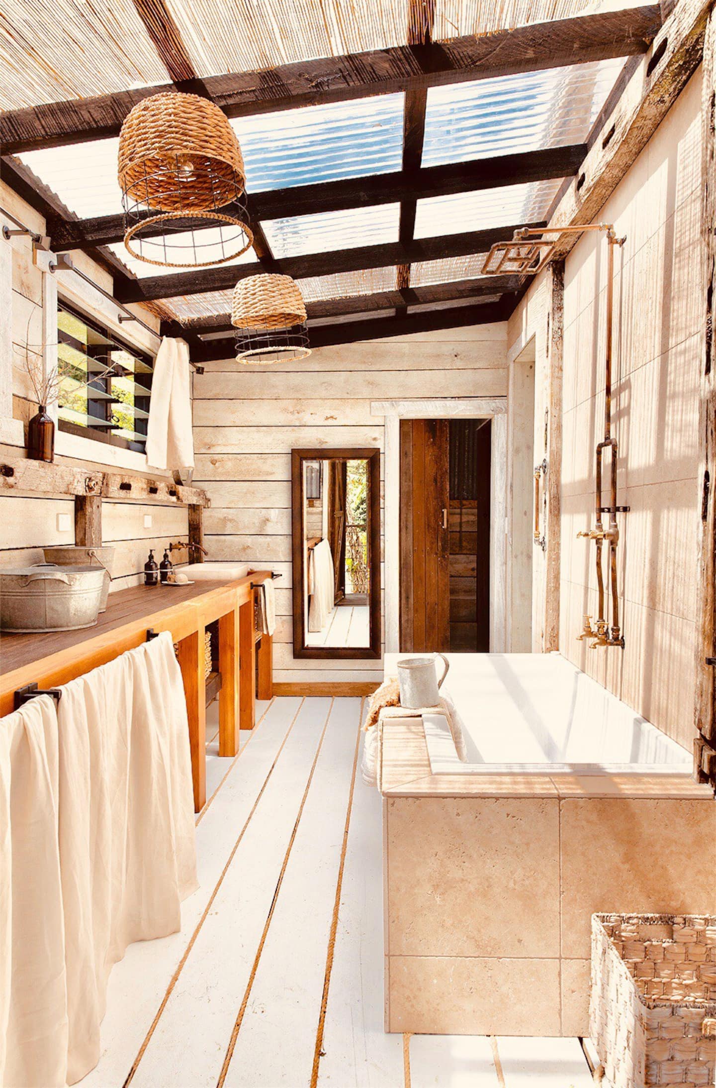 a bath in a shed style bathroom with a clear roof