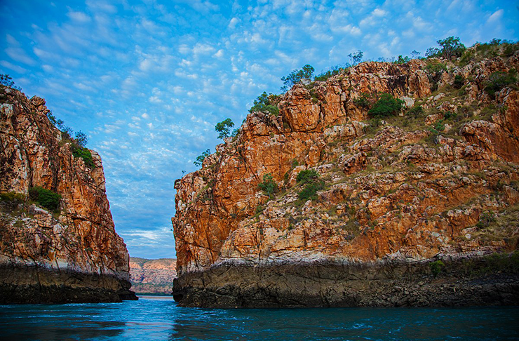 Western Australia's rugged Horizontal Falls set in front of crystal blue horizon.