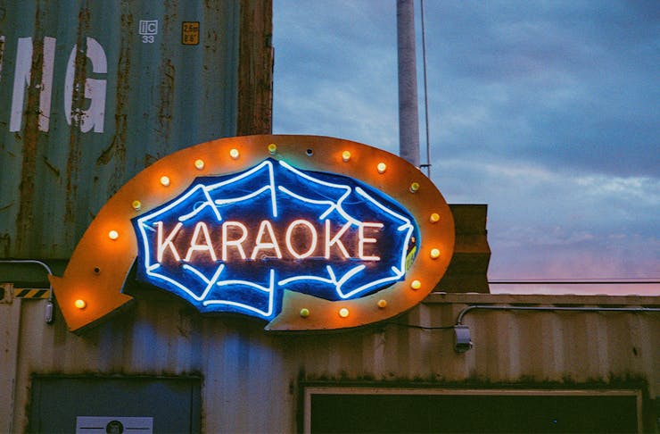 a neon sign saying 'karaoke'