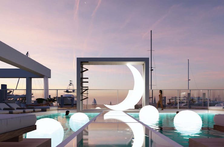 a pool with a giant luminescent moon sculpture
