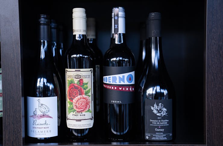 four bottles of wine on a shelf