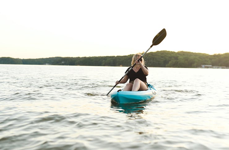 a person kayaking on a lake