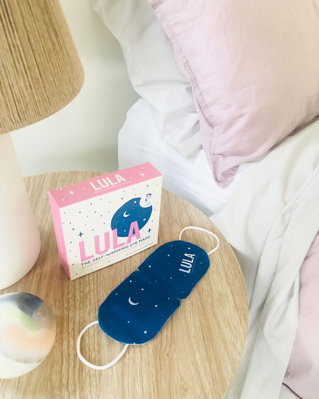 an eye mask on a bedside table