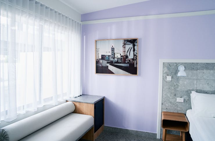 a purple room with a vintage photograph and a vintage couch