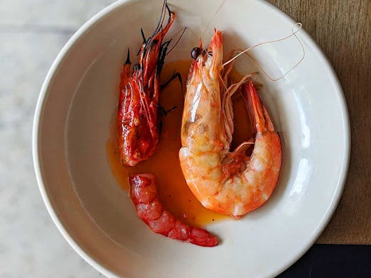A scarlet prawn dish plated up at Saint Peter restaurant in Paddington, Sydney