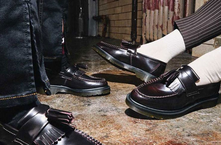 A photograph of models' feet in Dr Martens loafers. 