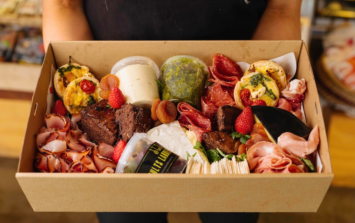 a gift hamper filled with cheese and antipasto