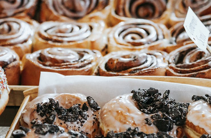 A close-up shot of glazed donuts and cinnamon rolls.