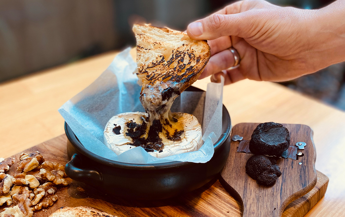 A baked brie with truffle shavings on top