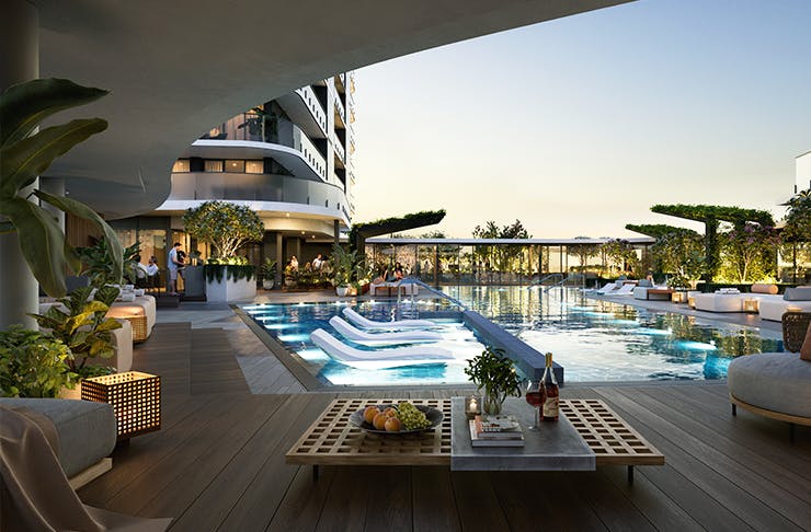 A luxury rooftop pool with lounge chairs and plants surrounding the pool deck. 