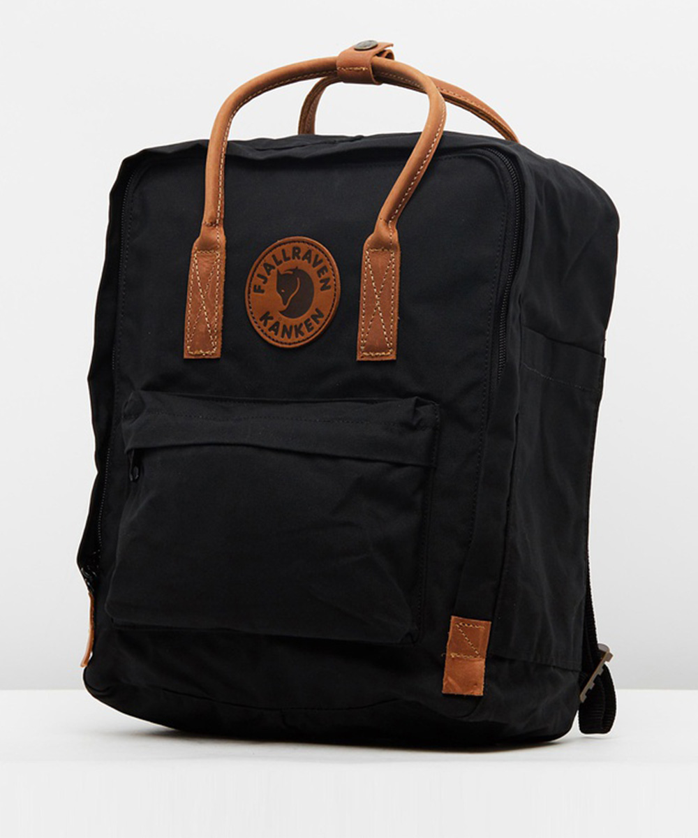 a black backpack with tan accents