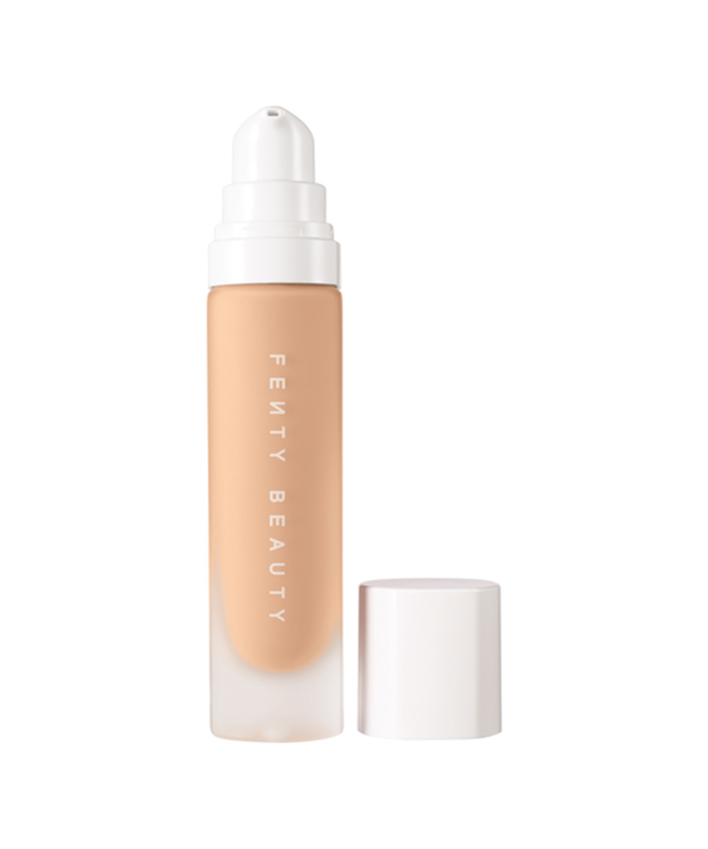 a glass bottle of foundation with a white lid.