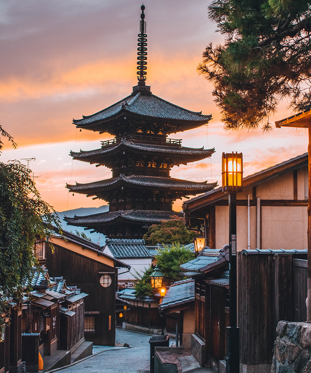a temple rises at sunset in Kyoto