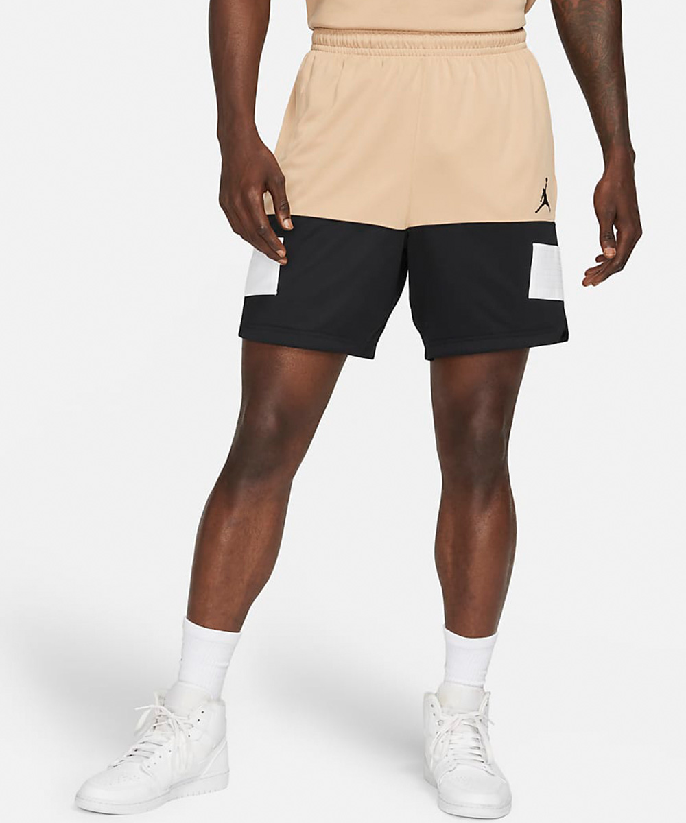 a pair of beige and black nike shorts