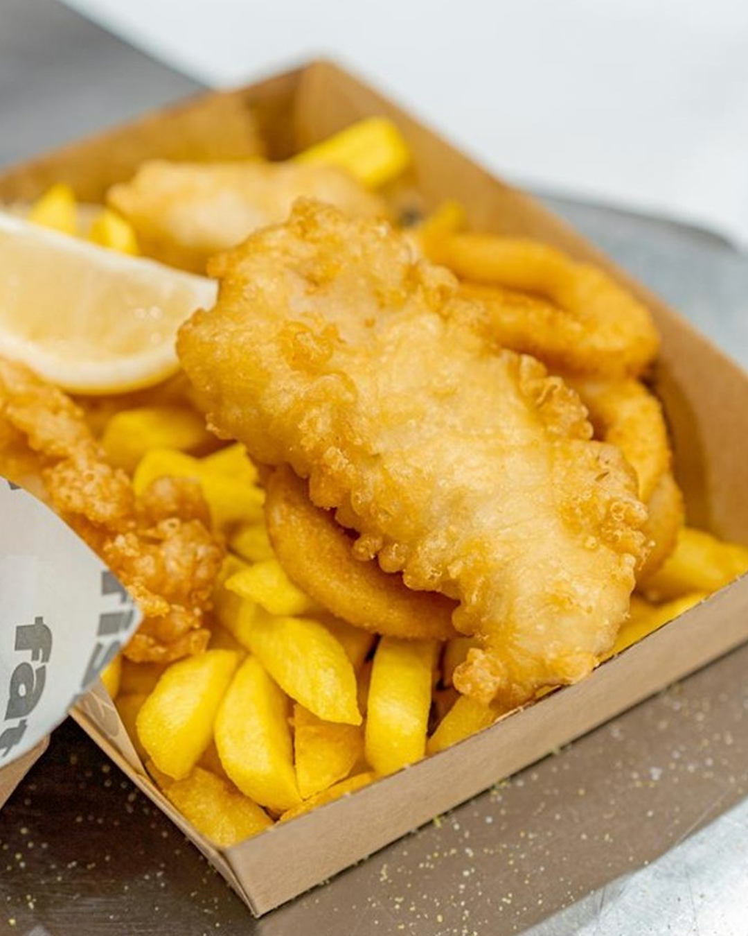 fish and chips in takeaway box