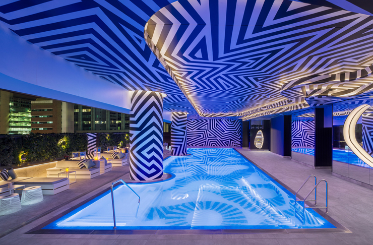 indoor pool surrounded by geometric wall design