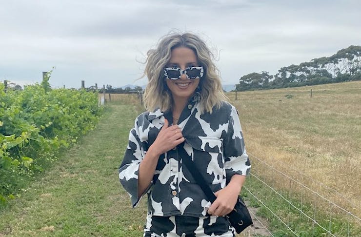girl wearing cow-print clothes and posing in vineyard