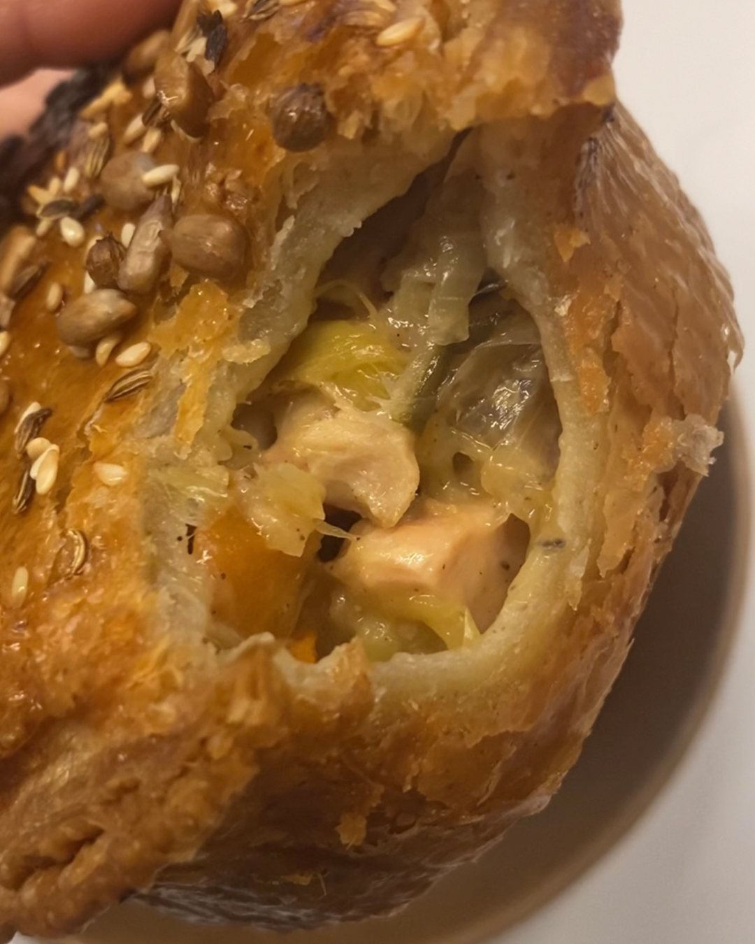 chicken and leek pie with one bite into it
