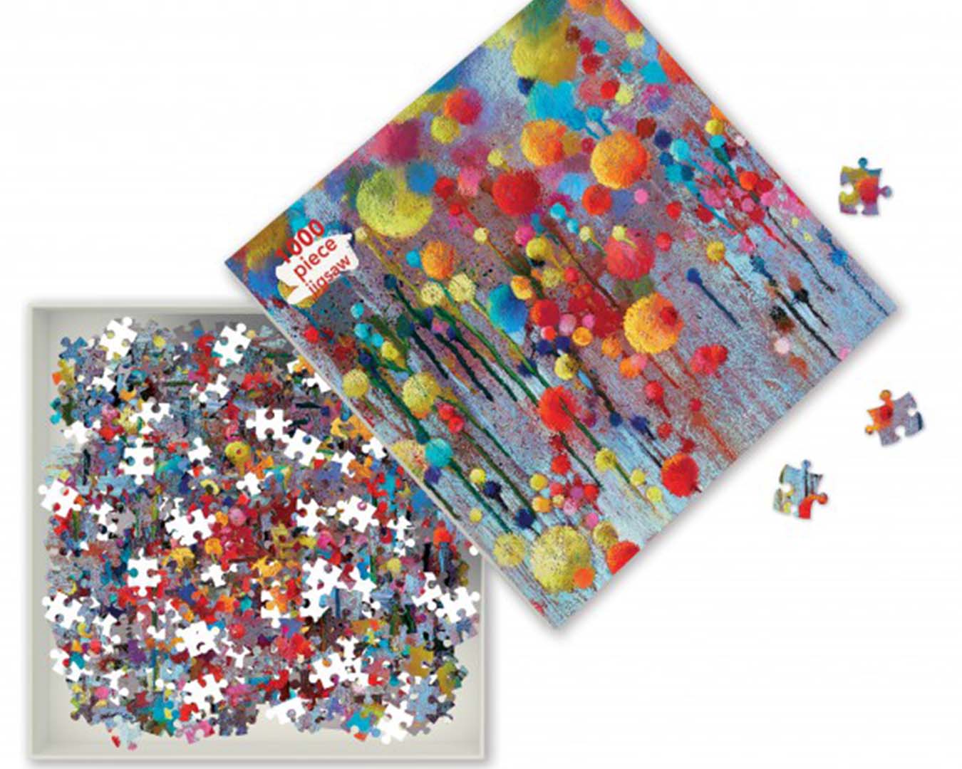 Open puzzle box showing a mixture of puzzle pieces and a colourful print on the box.