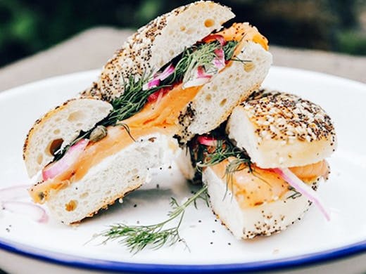 cream cheese and salmon bagel on rustic plate