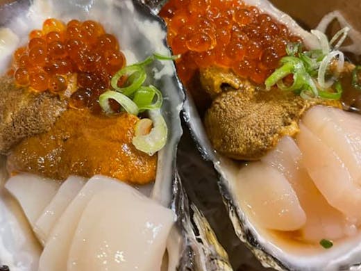 Two oysters with uni and salmon roe.